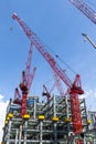 View of cranes above steel structure for building construction. Royalty Free Stock Photo