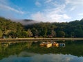 Beautiful early morning view of a creek with reflections of blue sky, mountains and trees on water Royalty Free Stock Photo