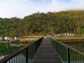 Beautiful early morning view of a creek with reflections of blue sky, foggy mountains and trees on water Royalty Free Stock Photo