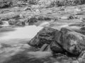 Black and white long exposure of a stream cascading over rocks in Montana