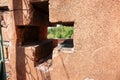 View through cross-shaped openings in thick walls of Portico of San Luca