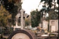 view of cross on a tombstone in a cemetery Royalty Free Stock Photo