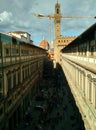 View of the crowded courtyard from the windows of Uffizi Gallery with a construction crane, the Cathedral dome and clock tower of Royalty Free Stock Photo