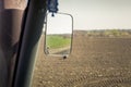 view of cultivator in upper backside mirror in tractor cabin Royalty Free Stock Photo