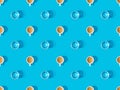 View of cups of fresh coffee and glasses of water on blue, seamless background pattern