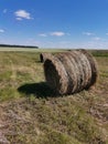View of cut hay bales on the  field, hills and clear  sky Royalty Free Stock Photo
