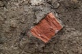 view of cut of soil with half of a brick Royalty Free Stock Photo