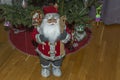 View of cute figure of Santa Claus on background of Christmas tree.