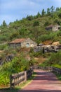 View of a cycle and pedestrian eco path, old ruin houses and vegetation as background