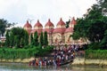 View Dakshineswar Kali Temple and devotees Ttaking bath in Hooghly river, Kolkata