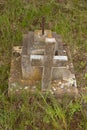 Damaged grave headstone with cross