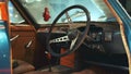 View of dashboard panel and steering wheel of antique car Triumph