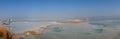 View of Dead Sea coastline with it`s beautiful sand and salt in the middle of the water. Aerial shot captured from the Royalty Free Stock Photo