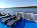 View from the deck of a cruise ship to a row of deck chairs near the side Royalty Free Stock Photo
