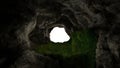 View from deep cave with grass, hole in rocky mountain, sunset. 3d render