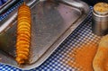 View of deep frying of spring or tornado potato chips,in oil ,by indian street food vendor