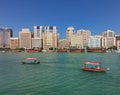 A view on Deira old city from the Dubai river with plenty of boats upon its waves