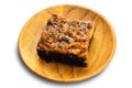 View of delicious homemade chocolate toffee cake topping with cashew nut and caramel in wooden plate Royalty Free Stock Photo