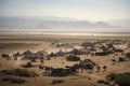 view of desert landscape, with camels and tribal tents in the distance