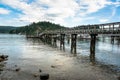 View of a Deserted Wooden Pier in a Harbour on a Cloudy Summer Day Royalty Free Stock Photo