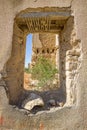 View through destroyed window of ruins of the abandoned village