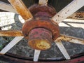 RUSTED HUB OF A OLD METAL WHEEL WITH SPOKES ON A CART Royalty Free Stock Photo