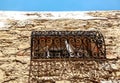 View of detail of stone building with typical Mediterranean arabic style window and balcony with ornament old forging in Medina. Royalty Free Stock Photo