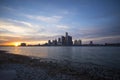 View of Detroit city skyline at sunset from the shore of the riv