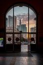 Skyline of Frankfurt am Main, sunrise with a view through a glass door towards the city. Main station entrance