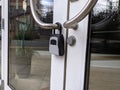 View of a digital padlock on glass office building doors Royalty Free Stock Photo