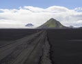 View on dirt mountain road F210 in black lava sand desert at Nat