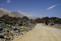 View from dirt road on dry barren mountain range in Atacama desert, Chile Royalty Free Stock Photo