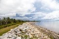 View of a dirt wall of boulders along the shore of the Atlantic ocean, Guyana on the background of blue sky