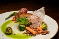 view on dish of piece of baked meat with buckwheat and vegetables on plate