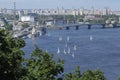 View of Dnieper river, buildings and sailboats floating on water