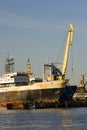 A view of the docks in Kleipeda, Lithuania. A rusty old looking ship is moored there.