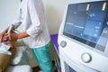 View of doctor using radial shockwave therapy machine in beauty parlor