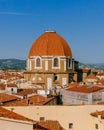 Dome of San Lorenzo Basilica under blue sky, over houses of the historical center of Florence, Italy