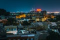 View of the Domino Sugars Factory and houses in Federal Hill at night, in Baltimore, Maryland