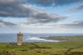 View on Doonagore castle, Doolin pier and Aran islands in the background. Beautiful cloudy sky. Popular tourist attraction in Royalty Free Stock Photo