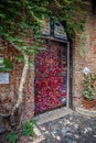 View of the door with love notes and padlocks at Juliet`s house yard