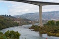 View on Douro river bridges near Peso da Regua and colorful hilly stair step terraced vineyards in autumn, wine making industry in