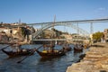 View of the Douro River with rabelo boats, the iconic Dom Luis Bridge and the Ribeira neighbourhood in Porto, Portugal Royalty Free Stock Photo