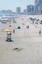 View down the Atlantic city, New Jersey beach showing a lifeguard stand with a yellow umbrella. There are tire tracks in the sand Royalty Free Stock Photo