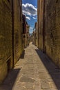 A view down a narrow alleyway at siesta time in the city of Gubbio, Italy