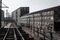 View down railroad tracks alongside abandoned industrial buildings Royalty Free Stock Photo