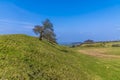 A view down the side of the eastern ramparts of the Iron Age Hill fort remains at Burrough Hill in Leicestershire, UK Royalty Free Stock Photo