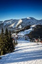 View down of a snowy ski slope in alpine mountain valley Royalty Free Stock Photo