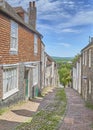 View down a steep cobbled street in summer sunshine Royalty Free Stock Photo