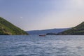 View down the strait with mountains over the famous Kotor Bay with a red boat near Perast, Montenegro Royalty Free Stock Photo